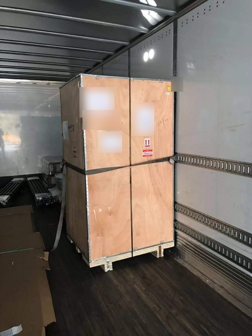Crated equipment strapped on the truck